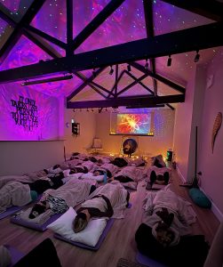 A sound bath in a studio with a colourful backgound