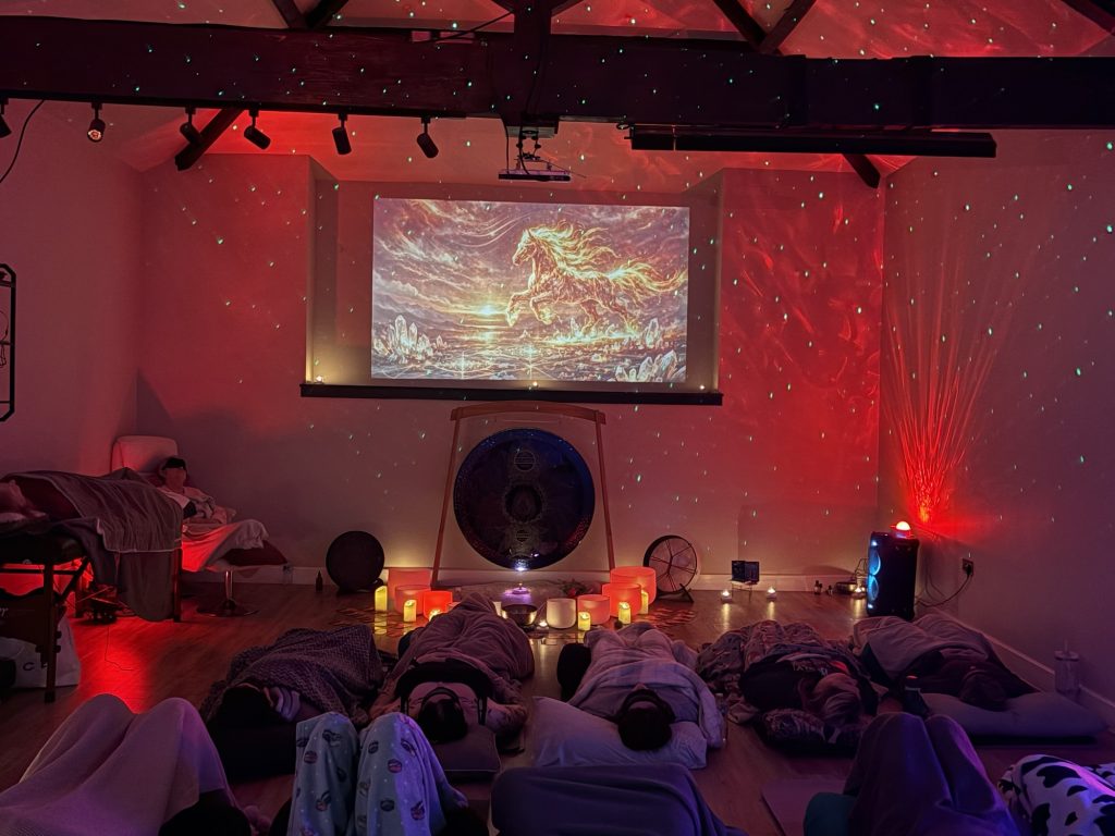 A sound bath in a studio with a colourful backgound