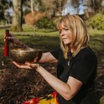 A blonde woman with a sound bowl