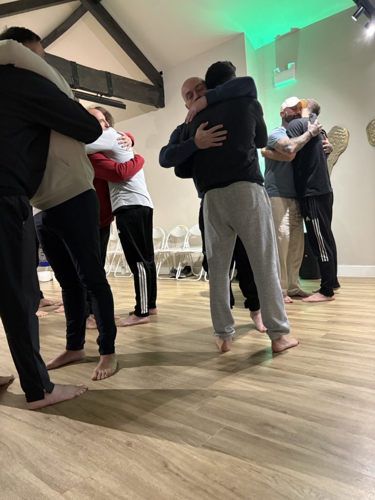 Men Hugging in a Yoga Studio